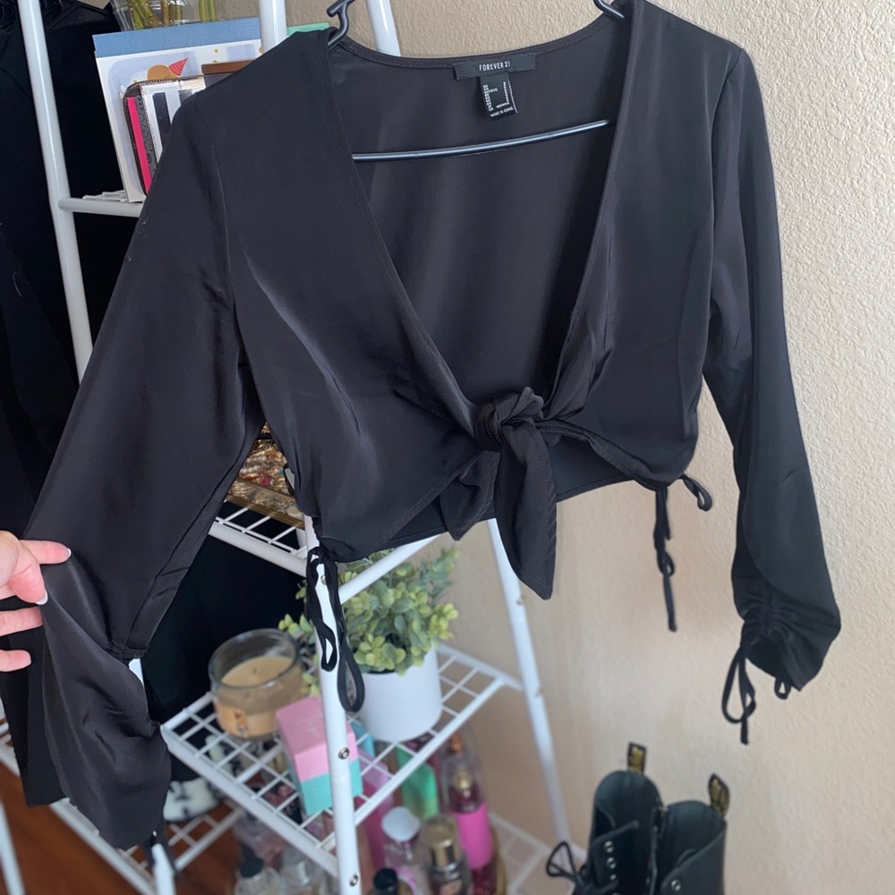 Black cropped tie-in-front blouse with singed arms.